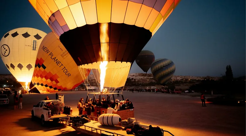 Balloon drifting past fairy chimneys with spring wildflowers below