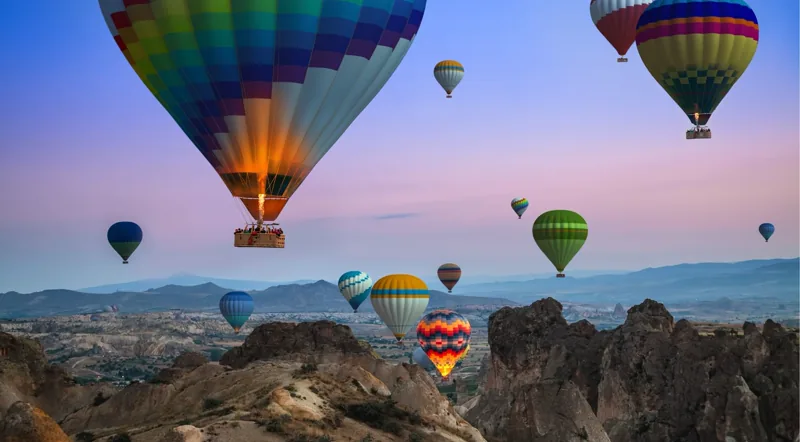 Dense balloon traffic over Göreme in mid-summer
