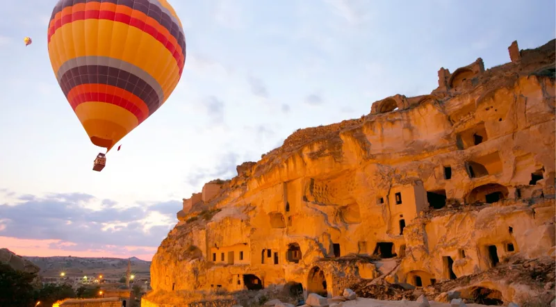 Balloon at sunrise over rose-coloured valleys in early autumn